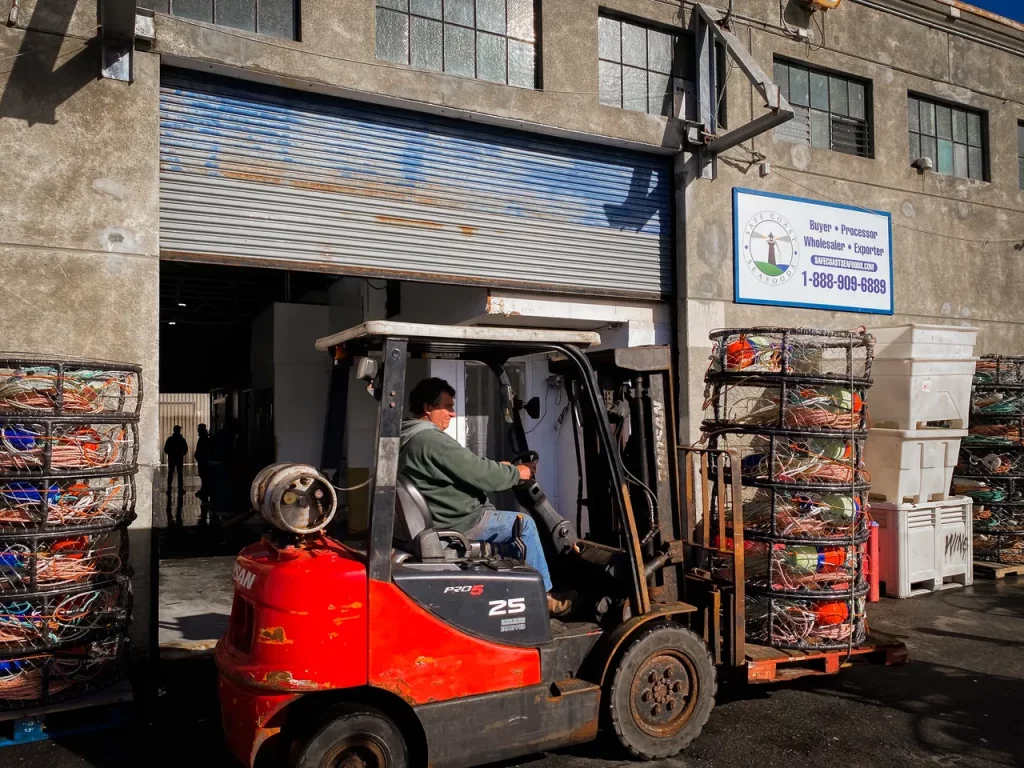 man transporting dungeness crab pots with forklift